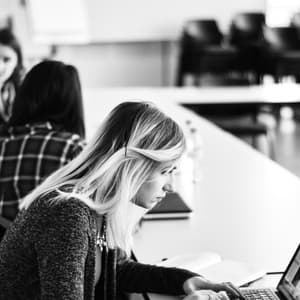 Woman staring at laptop.