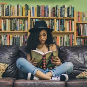 Woman sitting while mindfully reading book