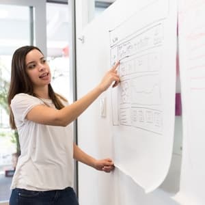 Woman giving presentation to team